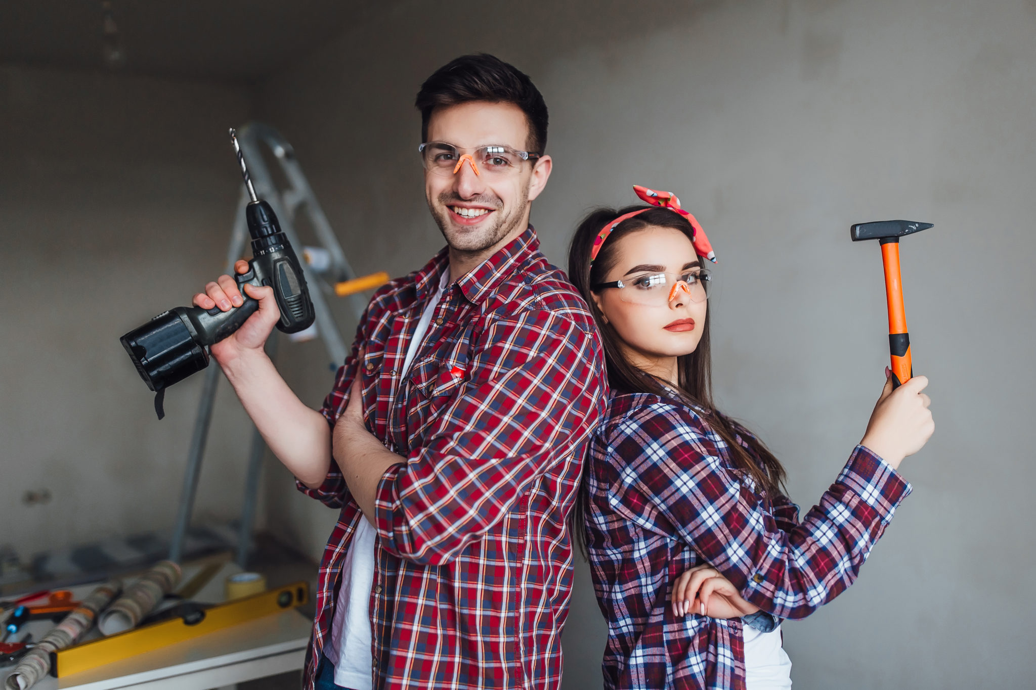 Young couple preparing for DIY appliance repair. 